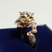 AN 18CT GOLD CARTIER DESIGN DIAMOND AND RUBY LEOPARD RING.