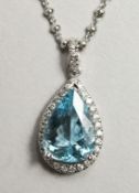 AN 18CT WHITE GOLD, AQUAMARINE AND DIAMOND PEAR SHAPE PENDANT AND CHAIN, the aquamarine approx. 4.