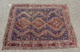 AN EARLY 20TH CENTURY KHAMESH RUG, dark blue ground with three central diamond shaped motifs. 6ft