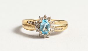 A 9CT GOLD BLUE TOPAZ AND DIAMOND CLUSTER RING