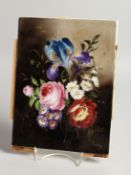 A GERMAN PORCELAIN PLAQUE painted with flowers. 9ins x 7.25ins