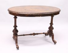A VICTOTIAN FIGURED WALNUT OVAL STRETCHER TABLE with quartered top carved edges on turned legs