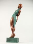 AN ABSTRACT BRONZE, STANDING FEMALE FIGURE. 26ins high