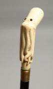 A WALKING STICK WITH A CARVED BONE OCTOPUS HANDLE 34ins long