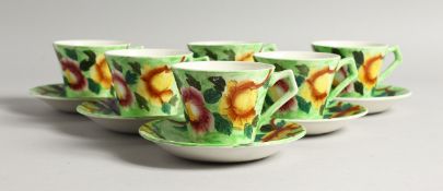 A SET OF SIX MALING PORCELAIN COFFEE CUPS AND SAUCERS, green ground, painted with flowers, pattern