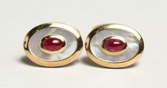 A PAIR OF 9CT. YELLOW GOLD, RUBY AND MOTHER OF PEARL OVAL CUFFLINKS