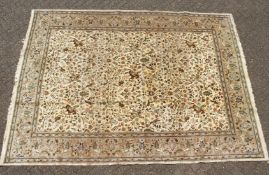 A LARGE PERSIAN HUNTING CARPET, cream ground with an all over hunting scene. 12ft 2ins long x 9ft