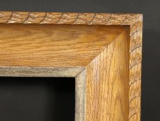 A carved oak frame with silvered inner ornaments, rebate size 24 x 36 , 61cm x 92cm.