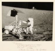 A photograph taken of the lunar landing from Apollo XII, signed and dedicated on the mount by