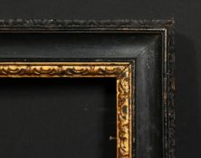 An 18th century carved and ebonised frame with a gilded inner ornament, rebate size 16 x 20.25
