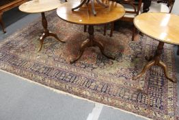 A large Persian carpet with allover floral decoration.