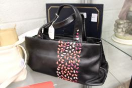 A Radley black leather handbag with dust cover.