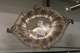 An embossed silver twin handled dish.