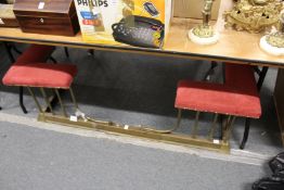 A brass and upholstered club fender.