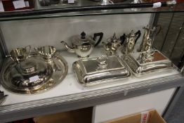 A pair of plated entree dishes and covers, a three piece tea service and other plated items.