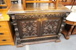 A Victorian Jacobean revival carved oak sideboard.