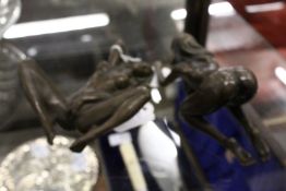 A pair of small erotic bronze figures.
