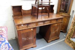An Indian hardwood pedestal sideboard with upper section over three frieze drawers and pair of