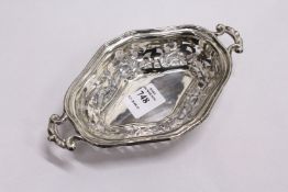 A pierced silver twin handled bonbon dish.