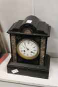 A Victorian black slate mantle clock.