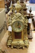 An ornate gilt metal mantle clock.