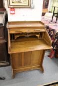 A small oak roll top desk.