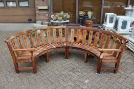 A two part semi-circular hardwood garden bench.