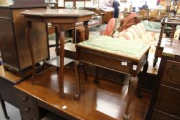 A mahogany occasional table and a music seat.