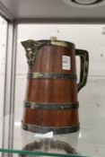 A wooden jug with plated mounts.