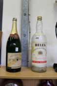 A large bottle of old champagne and a Bell's whisky bottle (no contents).
