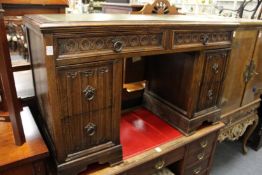 A carved oak pedestal desk.