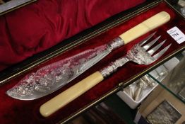 A cased set of silver fish servers with engraved decoration.