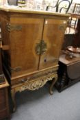 A decorative ormolu mounted walnut cocktail cabinet.