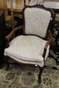 A pair of French style mahogany framed open armchairs.