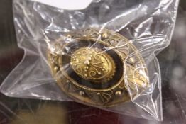 A gilt metal target brooch.