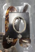 A miniature picture frame and various items of tortoiseshell.