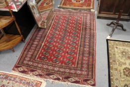 A Persian Bokhara rug.