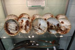 A set of ten Spode cabinet plates painted in a sepia style with various Scottish and other landscape