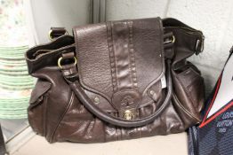 A ladies' brown leather handbag.