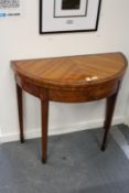 A good satinwood demi-lune foldover card table.
