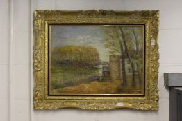 A river landscape with buildings and trees, oil on canvas, in a decorative gilt frame.