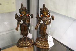 A pair of eastern bronze deities inset with coral.