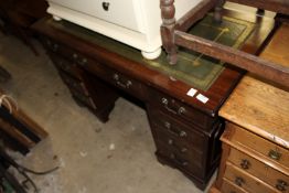 A reproduction mahogany pedestal desk.