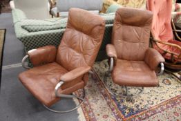 A pair of swivel reclining armchairs.
