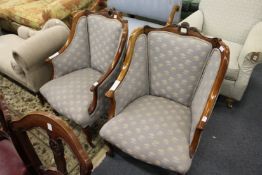 A pair of mahogany framed and upholstered armchairs.