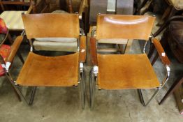 A pair of leather upholstered and chrome framed cantilever style armchairs.