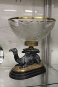 An impressive bronze and cut glass centrepiece modelled as a bowl mounted on the back of a seated