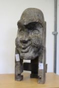 A carved wood bust.