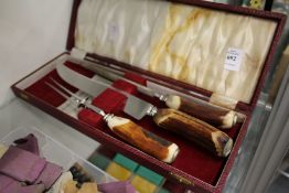 A cased carving set with antler handles.