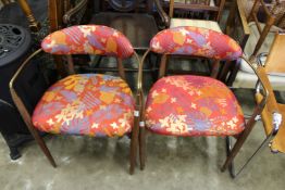 A pair of Scandinavian teak brass and upholstered armchairs.